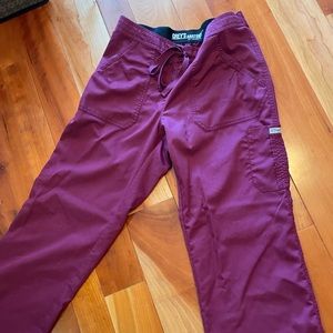 Maroon Grey’s Anatomy scrub pants with cargo pockets.